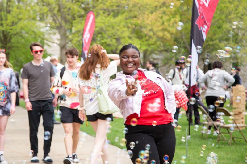 Student on campus doing Snouts Out