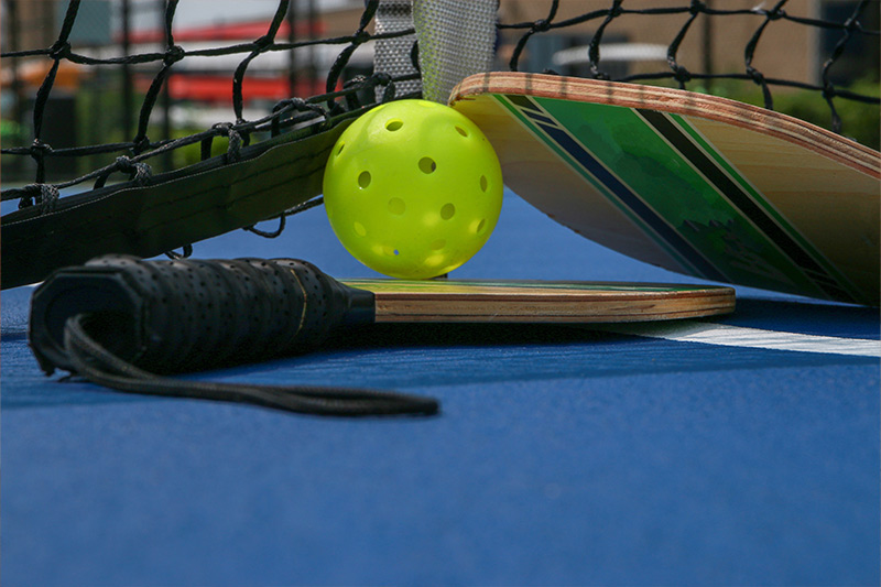 Pickle ball paddles and a ball