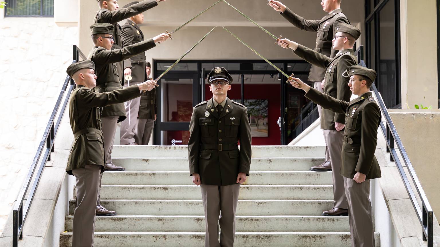 UCM cadets holding swords above another cadet who has just been commissioned as an Army officer