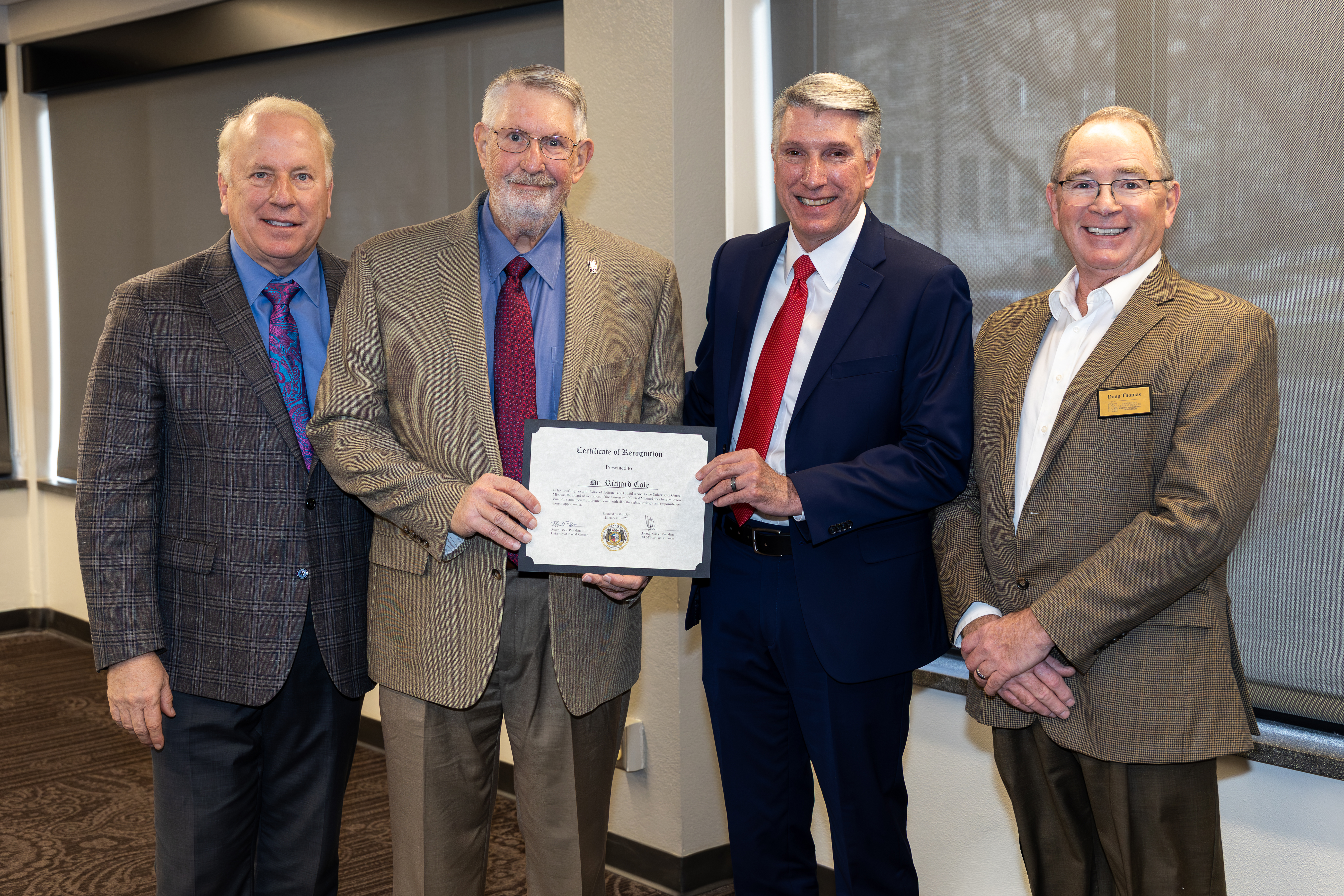 Dr. Richard Cole accepts his emeritus status certificate.