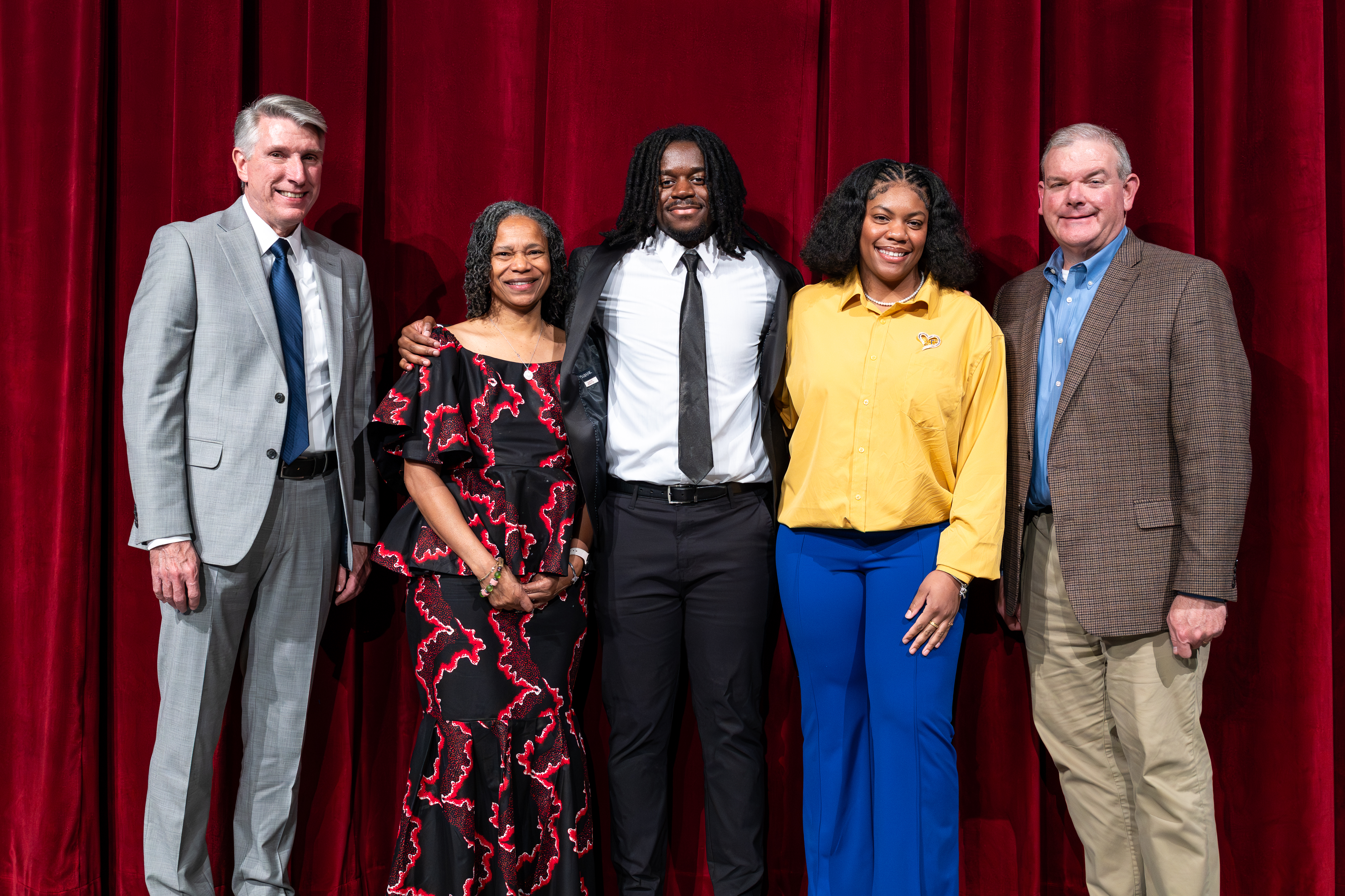 UCM leaders and two scholarship recipients pose for a photo